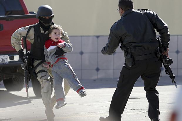 A policeman carries a child... Autors: Theinfernoisrefuge Photo (part 1 of 3)
